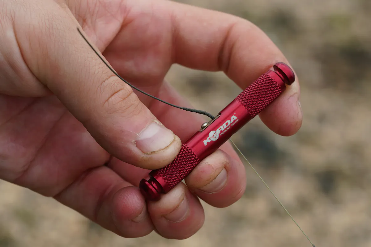 Take your coated braid, strip 3-4 inches using a Strippa Tool - this exposed section helps the rig mechanics