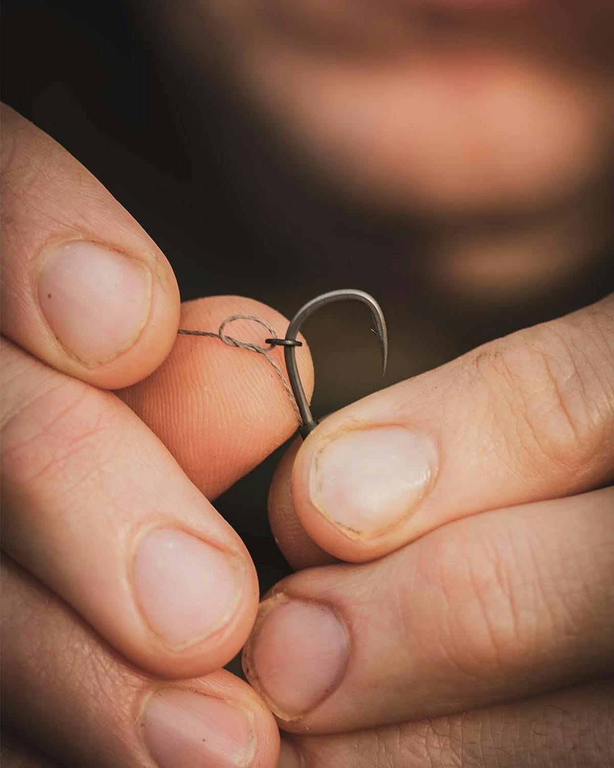 A rig ring or swivel can run freely up and down the shank and is attached to the hair so it exits at the optimum point opposite the barb