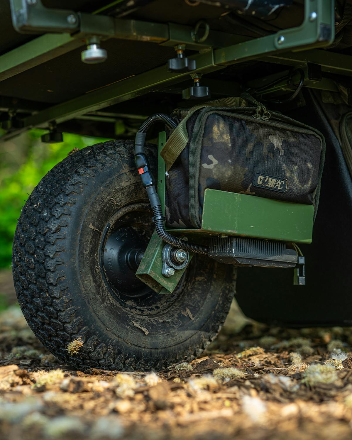 The Carp Porter Compac Battery Bag fits neatly alongside the wheel