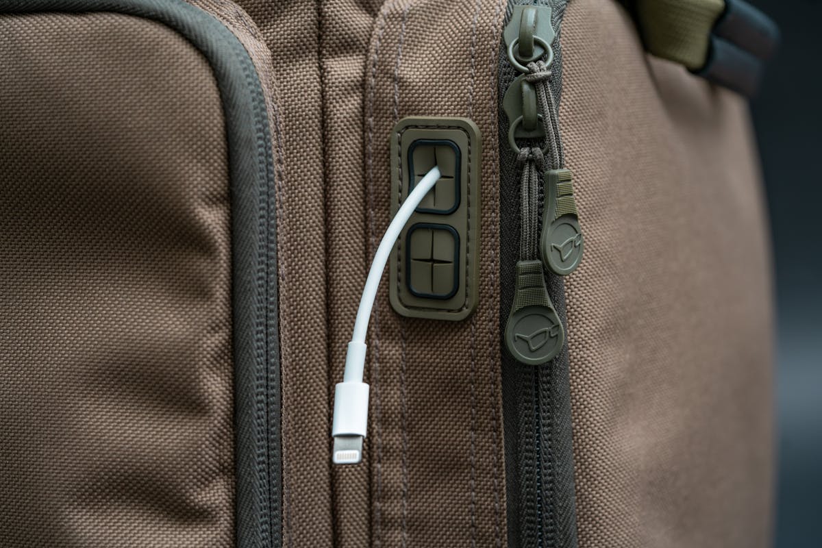 Four moulded cable ports allow power banks to be kept inside the pocket with the charging cable exiting neatly