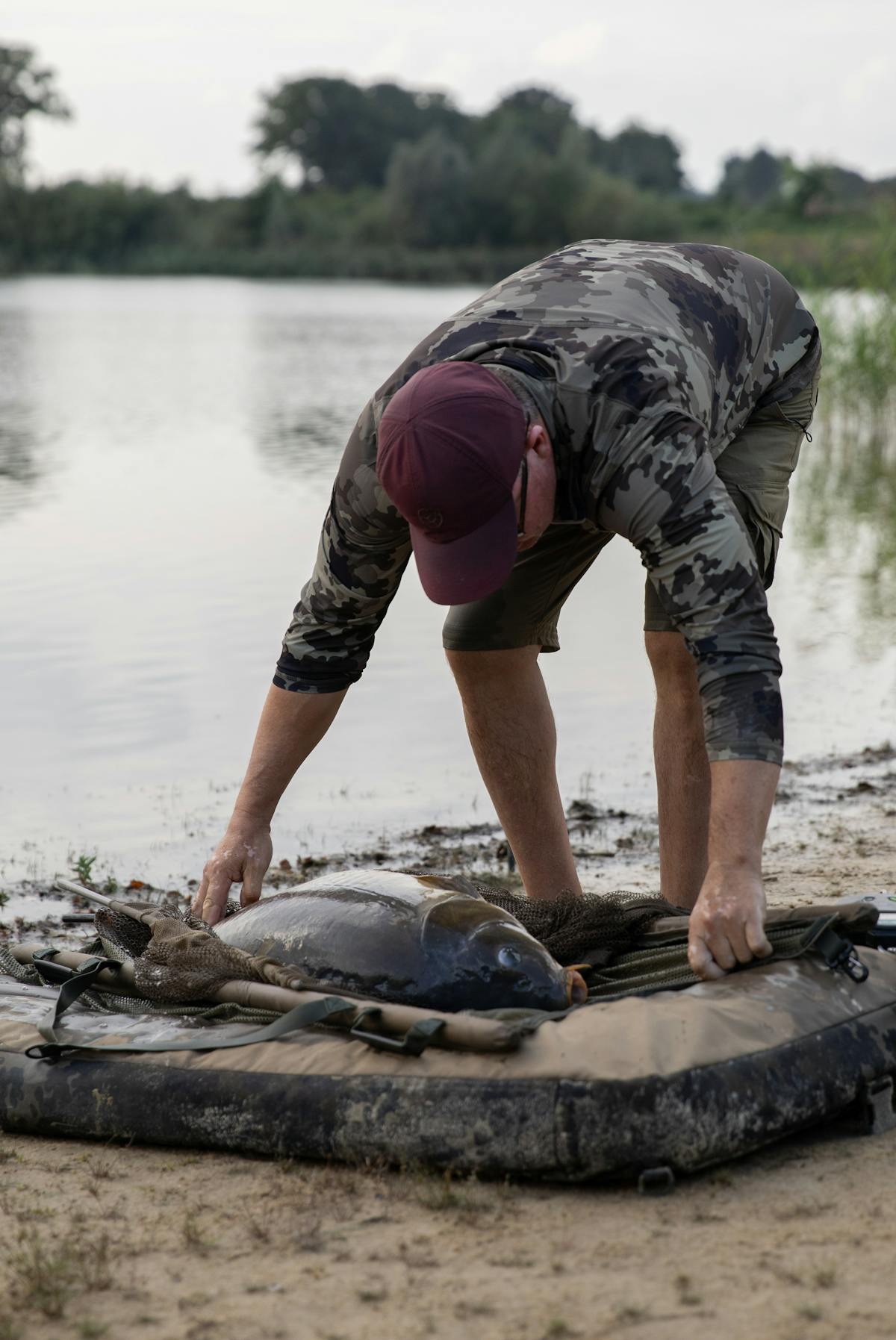 Once the fish is on the unhooking mat, carefully slide the net out from under it