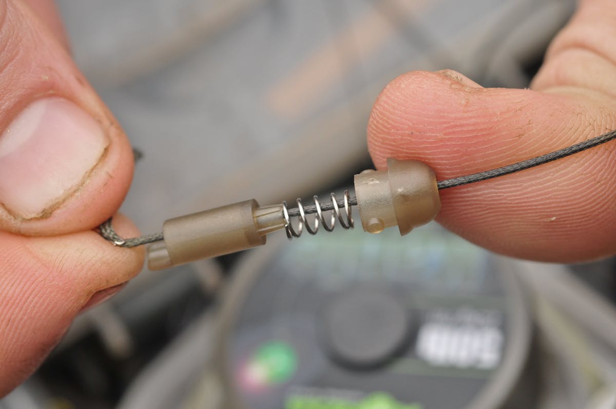 You can change the spring so more force is needed to eject the lead, or add a collar to stop it coming off