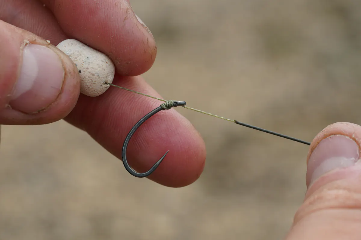 If using the KD Rig with a balanced bait like a wafter or a bottom bait with cork inserted, the rig will sink on its own, but if using a pop-up, pinch a split shot onto the hair directly below it