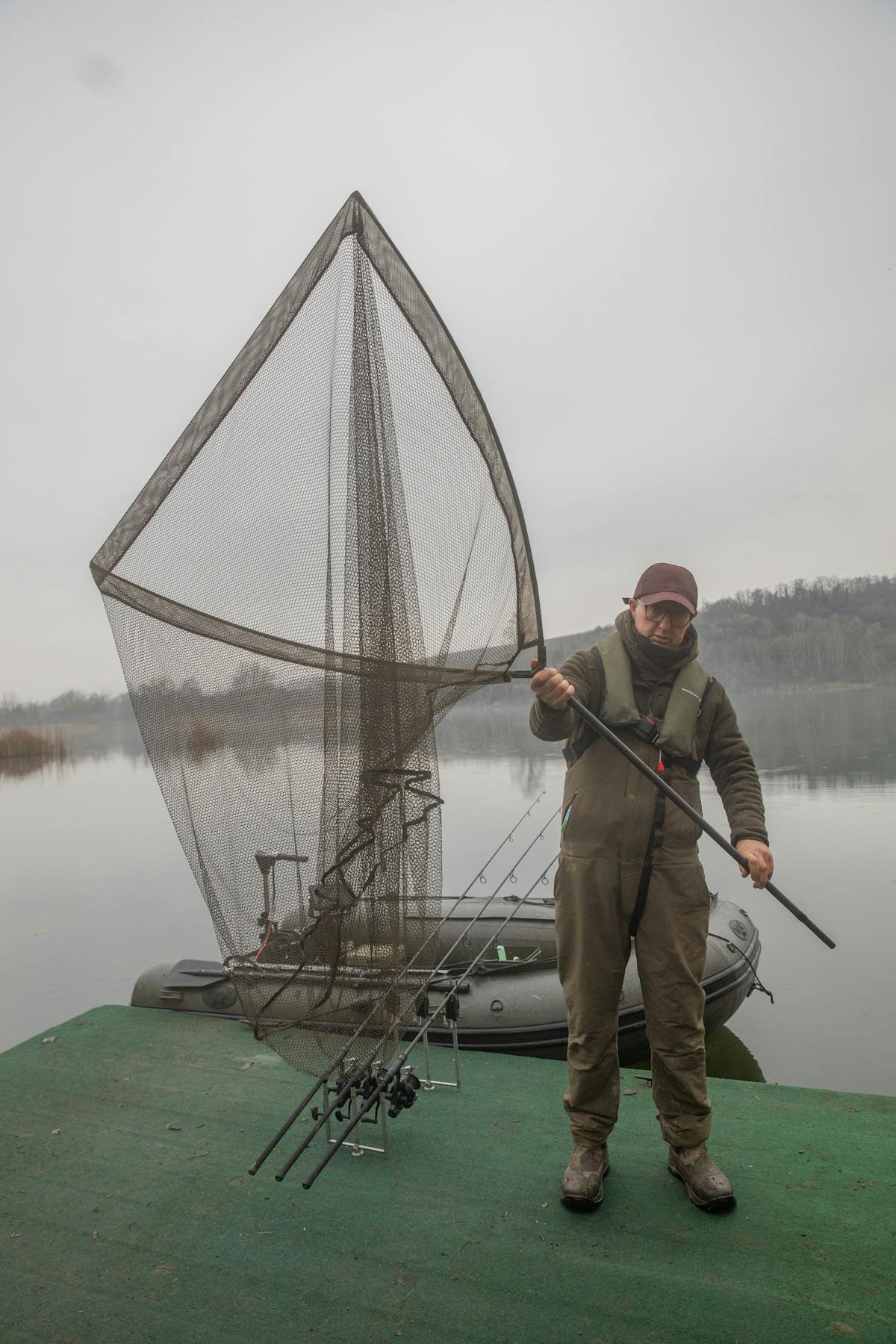 A landing net with a two piece handle, like the Kaizen Green model, is perfect for boat fishing