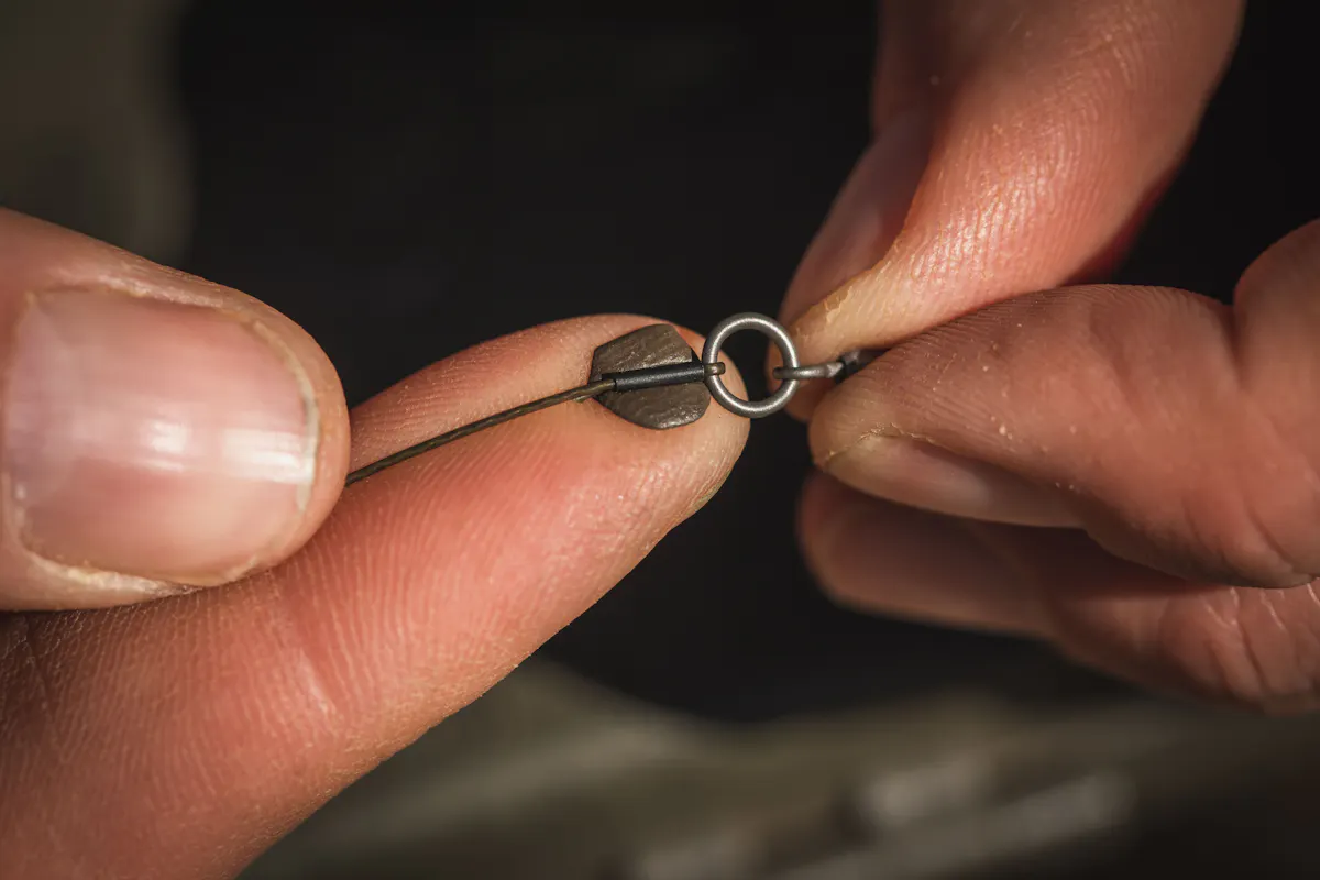 Take a piece of Dark Matter rig putty and mould it around the crimp at the hook section end of your boom