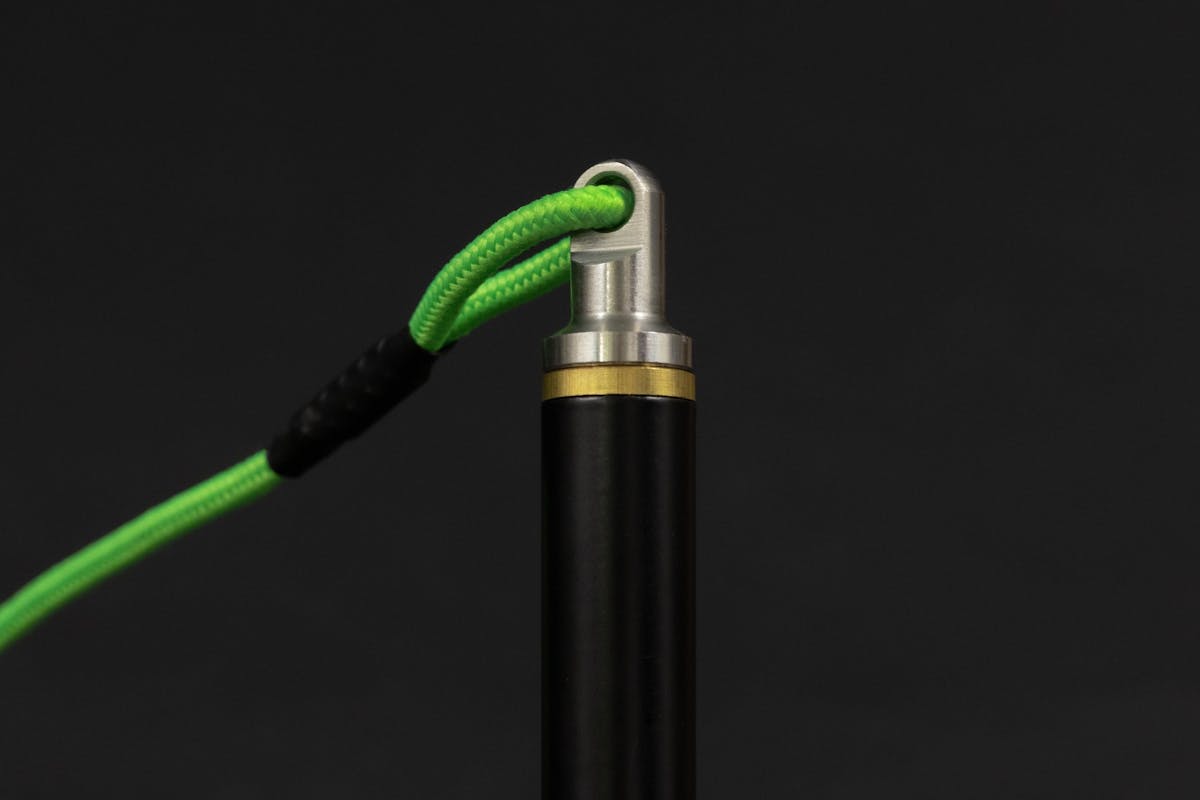 A machined stainless steel bank stick attachment secures the sling and cord