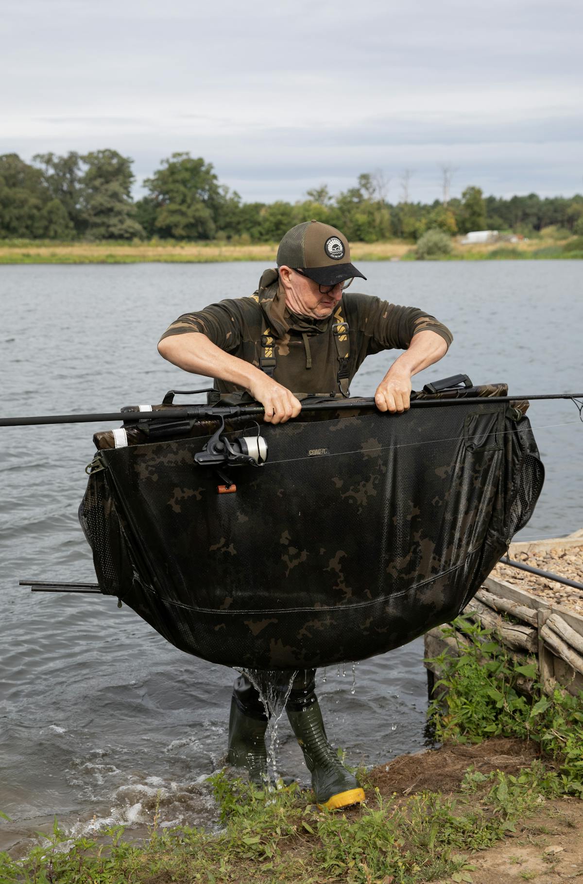 Carefully lift the carp out of the water in the sling and carry it to your unhooking mat