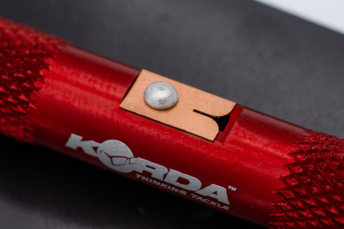 The Korda Strippa not only makes it simple to strip the coating off of coated braids but will will save your teeth from damage!